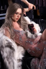 Callie sits backstage in a sparkling gown and white faux fur while her ash-blonde hair is being styled.