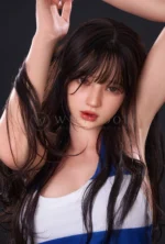 Evie with both arms raised, long brown hair and soft bangs surrounding her face.