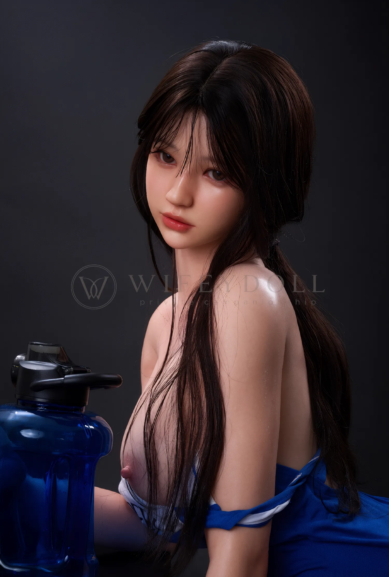 Evie in a blue-and-white swimsuit with long brown hair against a dark studio backdrop.