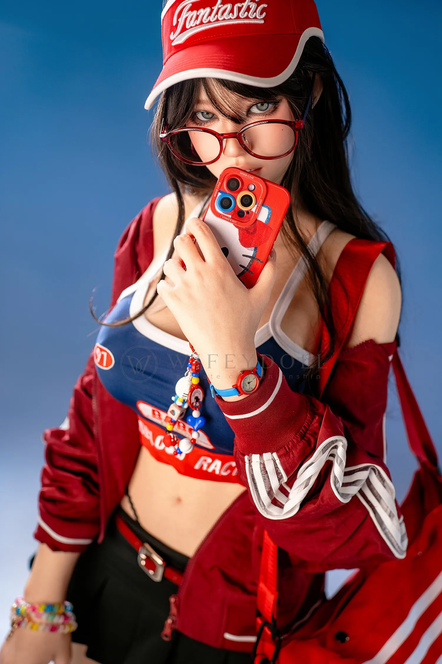 Close portrait of Hanae, a 161cm realistic sex doll, with red glasses, a red visor, and a red phone near her face.