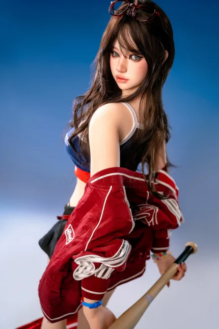 Hanae, a 161cm silicone sex doll, turns back over one shoulder with the baseball bat held behind her and the red jacket lowered around her arms.