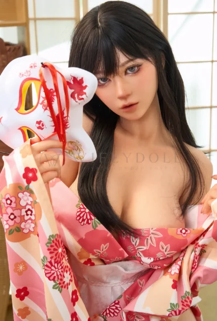 Close-up portrait of Kagura, an Asian silicone doll holding a fox mask.
