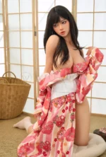 Kagura realistic silicone doll seated sideways on tatami in a pink floral kimono.