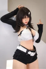 Upper-body portrait of Kitty in a white lace top and open black cardigan, with dark hair falling over her shoulders.