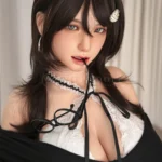 Close-up portrait of Kitty in a black-and-white academy look, with dark layered hair and a pearl hair clip.
