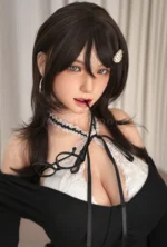 Close-up portrait of Kitty in a black-and-white academy look, with dark layered hair and a pearl hair clip.
