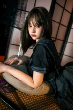 Mika, a 161cm realistic sex doll, reclining across a floor cushion in the sailor outfit, upper body turned back and legs bent behind her.