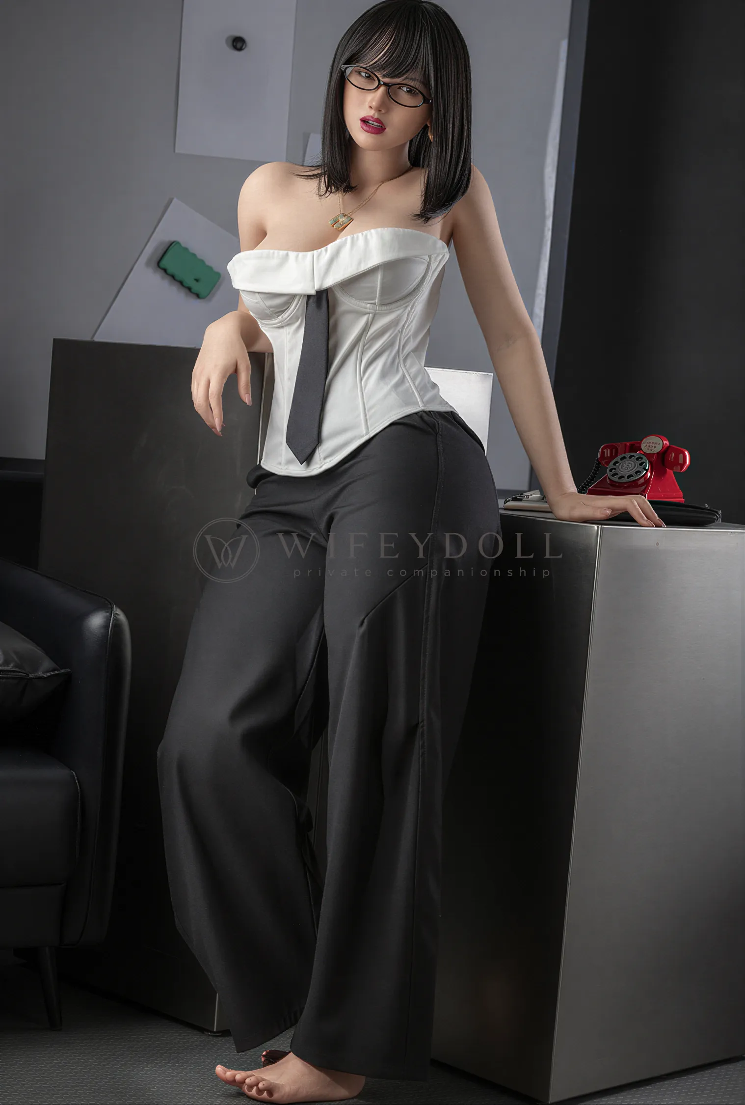 Miya stands beside the white pedestal in a white corset and black trousers, with a red phone behind her.