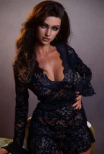 Monica Latina silicone doll leaning forward in black lace styling.