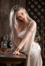 Nerissa realistic silicone doll leaning from the back on a wooden chair.