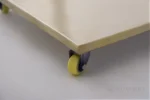 A detailed view of the doll display stand showing the caster wheel for stable support.