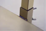 A detailed view of the doll display stand showing the height lock for stable support.