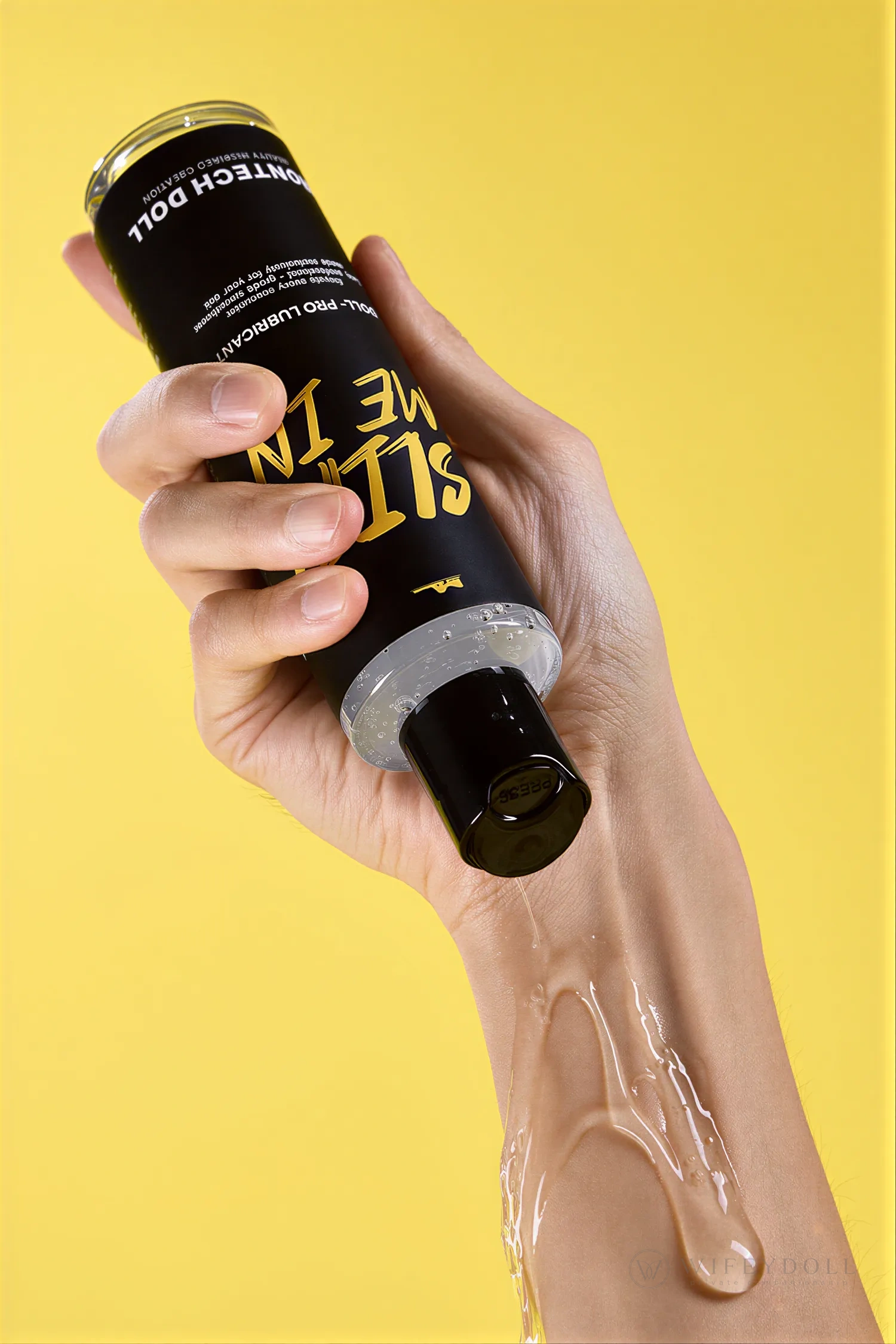 Clear Slip Me In lubricant spreads across a hand and wrist to demonstrate its fluid texture.