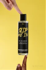 Close-up of the Slip Me In pump dispenser being pressed against a yellow background.