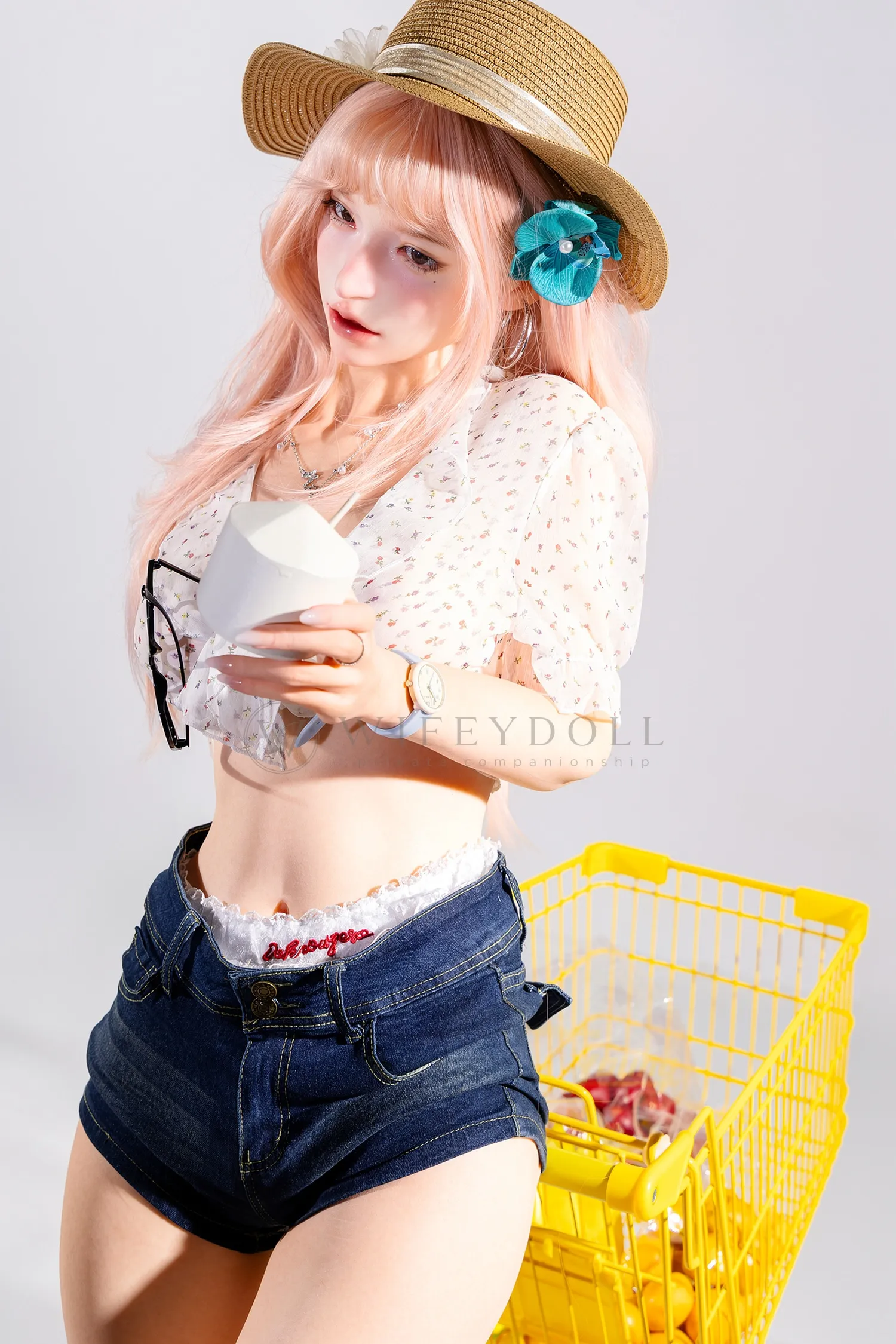 Mio, a 166cm realistic silicone doll, stands beside the cart holding a white cup.