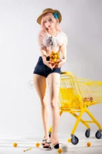 Mio, a 166cm silicone companion doll, stands facing forward with a basket of oranges beside the cart.