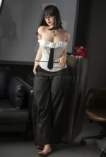 Miya, a 164cm WIFEYDOLL silicone sex doll, wears her signature professor look with glasses and a white corset.