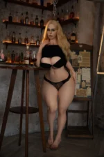 Pearl, a 164cm silicone companion doll, stands at the bar in black lingerie with one hand near her chin.