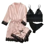 Flat lay of black lace nightwear with a pink satin robe.