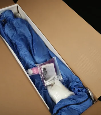 Open plain shipping box with protective wrapping inside.