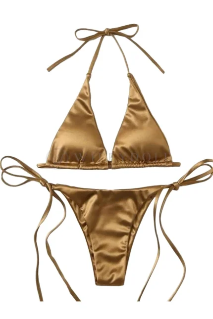 Flat lay of a gold bikini for doll styling.